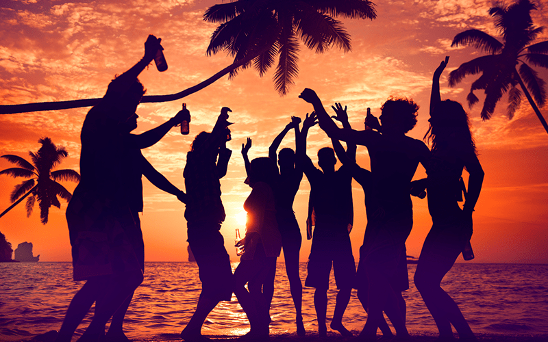 Group of people at dusk partying at the Malindi Peachy Beach Party