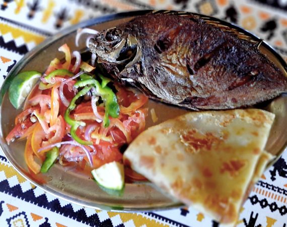 Shows grilled fish with salad at the Seafront Restaurant in Malindi Kenya